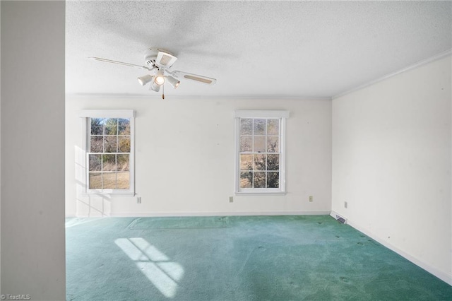 spare room with a textured ceiling, crown molding, carpet flooring, and ceiling fan