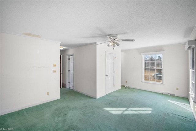 carpeted empty room with a textured ceiling, ornamental molding, and ceiling fan