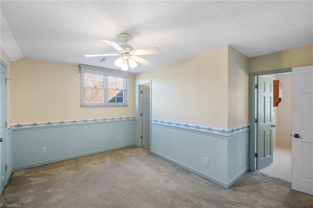 spare room with light carpet and ceiling fan