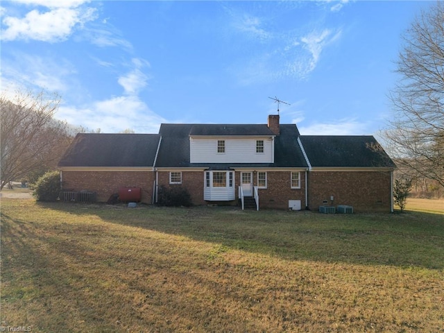 back of house with a yard and central AC