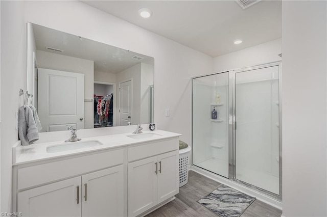 4997 Payne St, Trinity, NC 27370 - full bath with a stall shower, double vanity, wood finished floors, a spacious closet, and recessed lighting