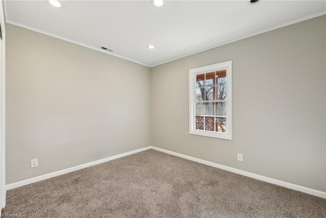 spare room featuring crown molding and carpet