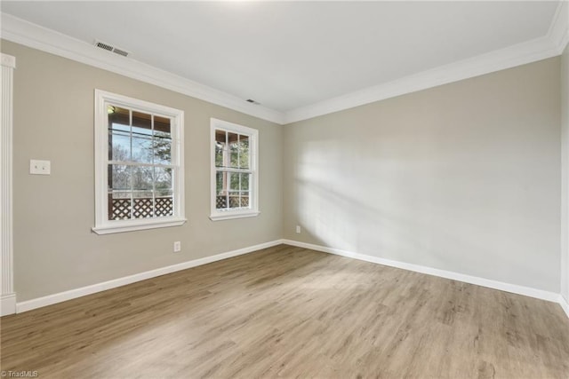 unfurnished room featuring ornamental molding and light hardwood / wood-style floors