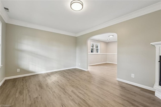 unfurnished living room featuring wood-type flooring and ornamental molding