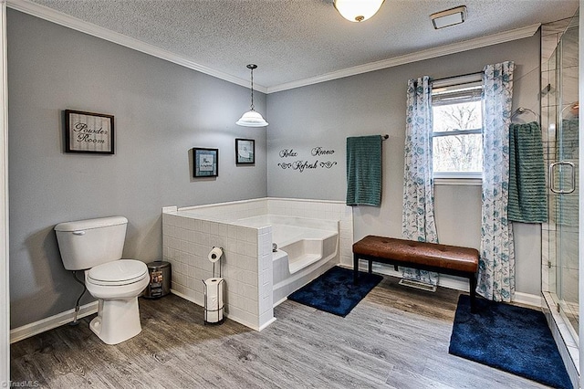 full bathroom with a garden tub, toilet, ornamental molding, a stall shower, and wood finished floors