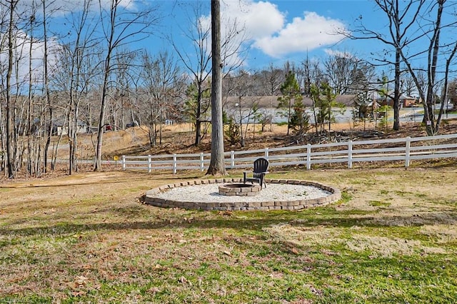 view of yard featuring a fire pit and fence