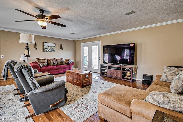 living area featuring ornamental molding and wood finished floors