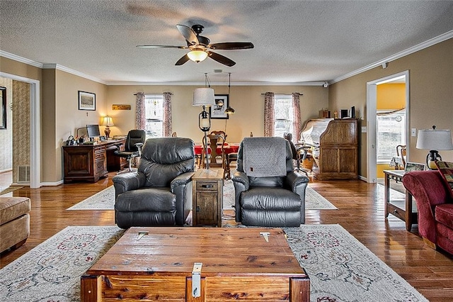 living room with crown molding, a wealth of natural light, and wood finished floors