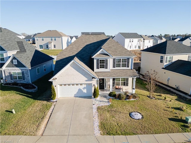 view of front of home featuring a front yard and a garage