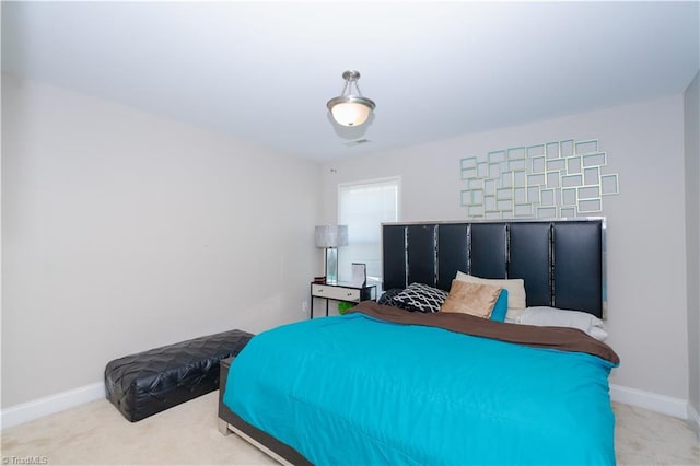 bedroom featuring light carpet