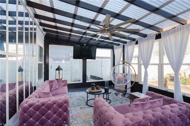 sunroom / solarium featuring ceiling fan and plenty of natural light