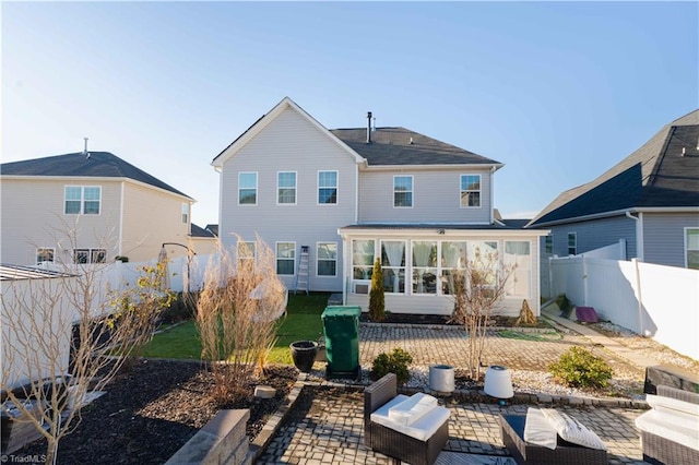 back of property featuring a sunroom and a patio area