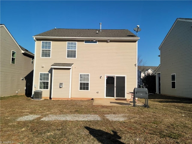 rear view of property with a lawn, a patio, and central air condition unit