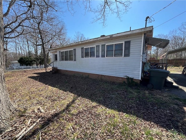 view of home's exterior with fence