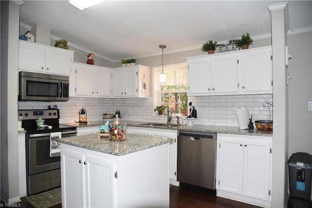 621 Southern Rd, King, NC 27021 - kitchen featuring stainless steel appliances, white cabinets, ornamental molding, a textured ceiling, and decorative backsplash