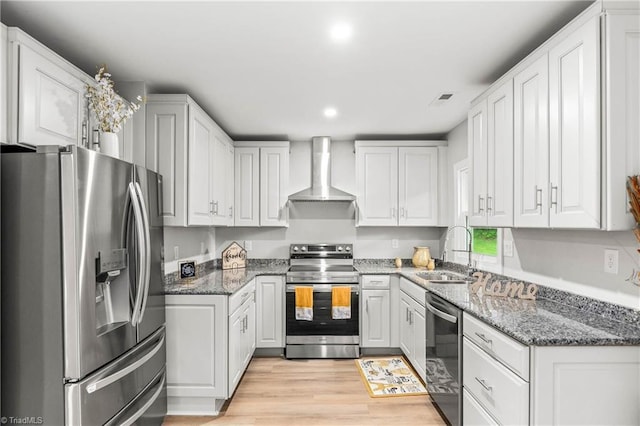 1732 Harrison Ave, Winston-Salem, NC 27105 - kitchen featuring stainless steel appliances, wall chimney range hood, white cabinets, stone counters, and light wood-style floors