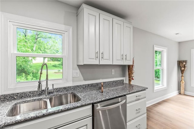 1732 Harrison Ave, Winston-Salem, NC 27105 - kitchen with dishwasher, white cabinetry, dark stone counters, and light wood-style flooring