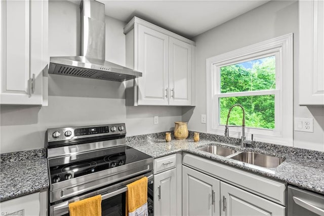 1732 Harrison Ave, Winston-Salem, NC 27105 - kitchen with wall chimney range hood, stainless steel appliances, white cabinets, and light stone countertops