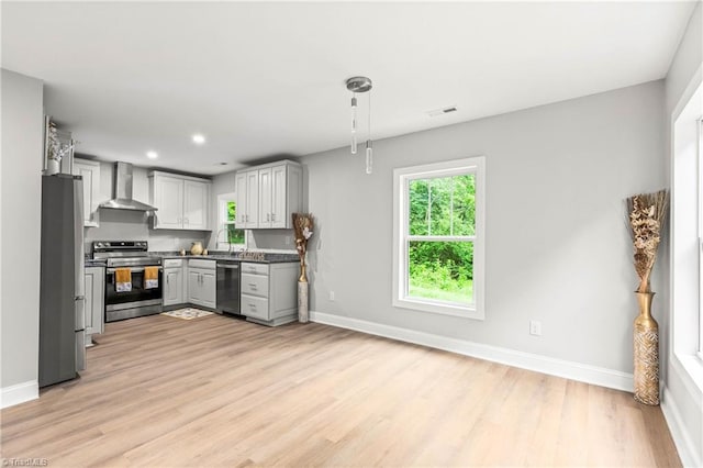 1732 Harrison Ave, Winston-Salem, NC 27105 - kitchen with stainless steel appliances, wall chimney range hood, light wood-type flooring, gray cabinetry, and recessed lighting
