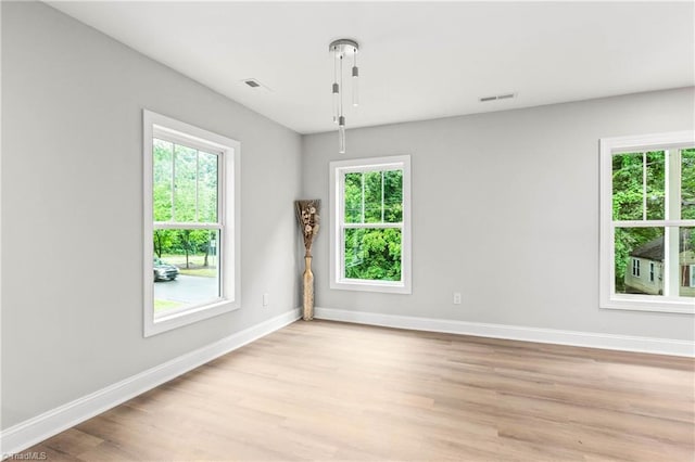 1732 Harrison Ave, Winston-Salem, NC 27105 - spare room featuring light wood-style flooring and plenty of natural light