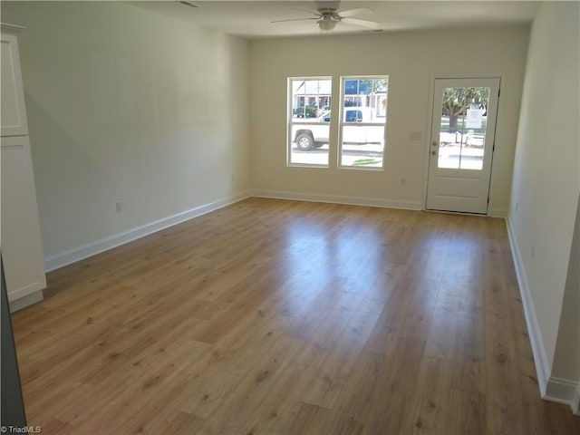 empty room with ceiling fan and light wood-type flooring