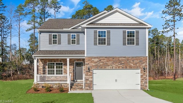 craftsman inspired home with a garage, covered porch, and a front lawn