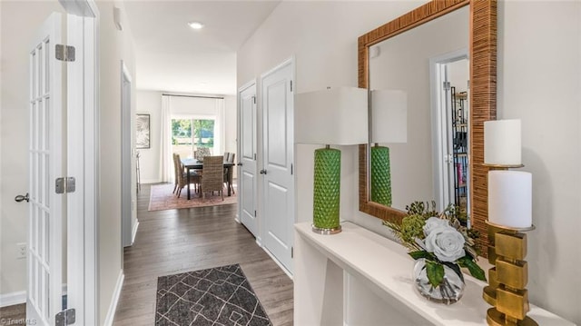 hallway with dark hardwood / wood-style flooring