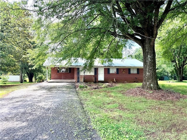 127 Forest Oaks Dr, Dobson, NC 27017 - ranch-style home featuring asphalt driveway and brick siding