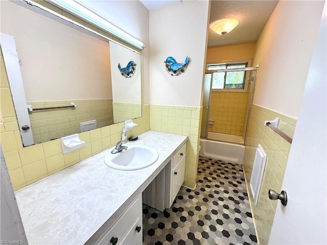127 Forest Oaks Dr, Dobson, NC 27017 - full bath featuring tile walls, tile patterned flooring, vanity, wainscoting, and enclosed tub / shower combo