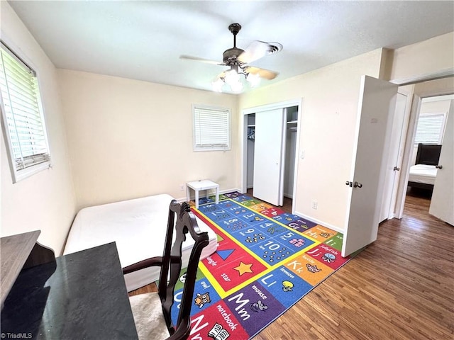 127 Forest Oaks Dr, Dobson, NC 27017 - bedroom featuring multiple windows, wood finished floors, a closet, and baseboards
