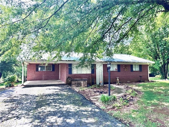 127 Forest Oaks Dr, Dobson, NC 27017 - ranch-style house with driveway, brick siding, and a carport