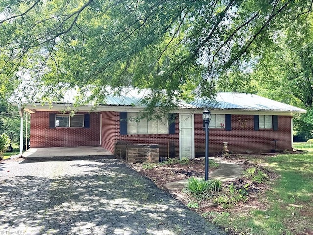 127 Forest Oaks Dr, Dobson, NC 27017 - ranch-style home featuring asphalt driveway, brick siding, and metal roof