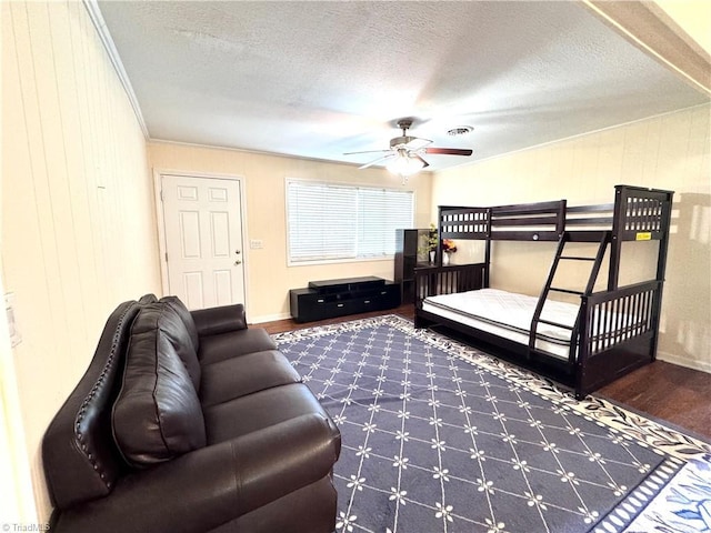 127 Forest Oaks Dr, Dobson, NC 27017 - bedroom featuring wood finished floors, a textured ceiling, ornamental molding, baseboards, and wood walls