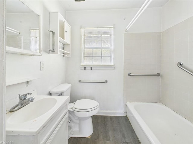 1008 E Brookline St, Winston-Salem, NC 27107 - bathroom with wood finished floors, toilet, vanity, washtub / shower combination, and baseboards