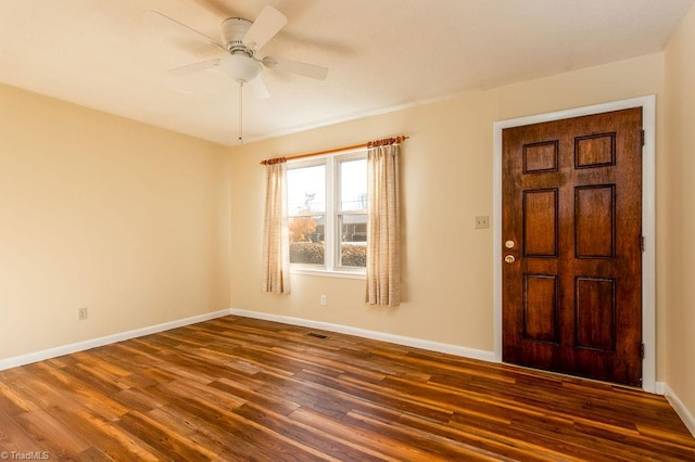 entryway with dark hardwood / wood-style flooring and ceiling fan