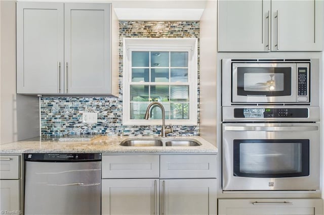 3640 Wyandotte Ave, Winston-Salem, NC 27127 - kitchen featuring appliances with stainless steel finishes, light stone countertops, and backsplash