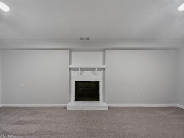 unfurnished living room featuring carpet floors, a brick fireplace, visible vents, and baseboards