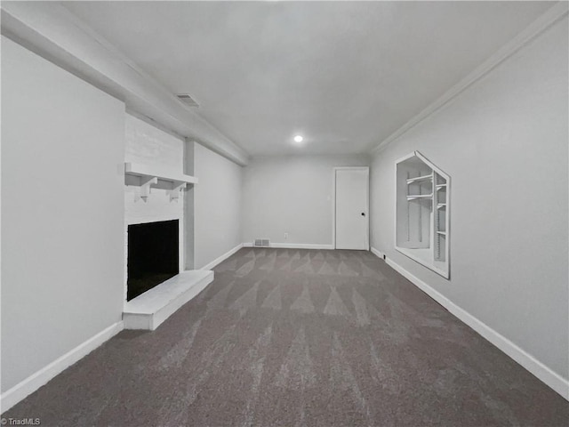 unfurnished living room featuring a brick fireplace, carpet flooring, visible vents, and baseboards