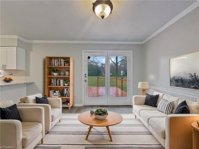 living area with crown molding and light wood finished floors