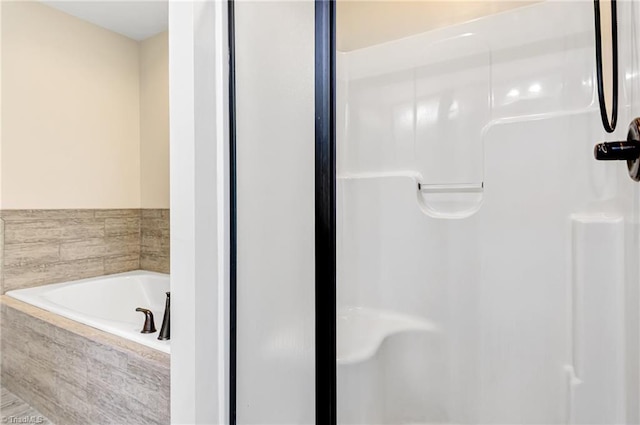 bathroom with a relaxing tiled tub