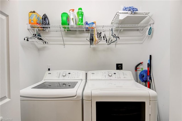 washroom with washing machine and clothes dryer