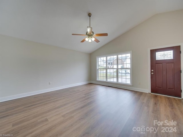 foyer featuring ceiling fan, light hardwood / wood-style floors, and lofted ceiling