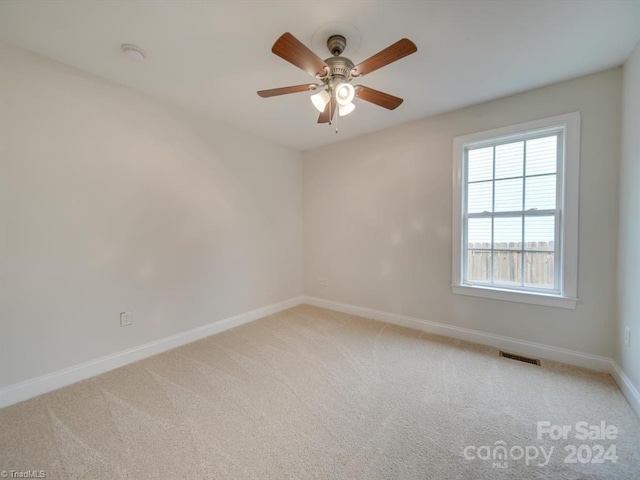 spare room with carpet floors and ceiling fan