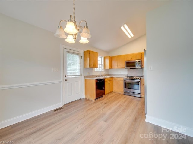 kitchen with lofted ceiling, an inviting chandelier, sink, hanging light fixtures, and appliances with stainless steel finishes