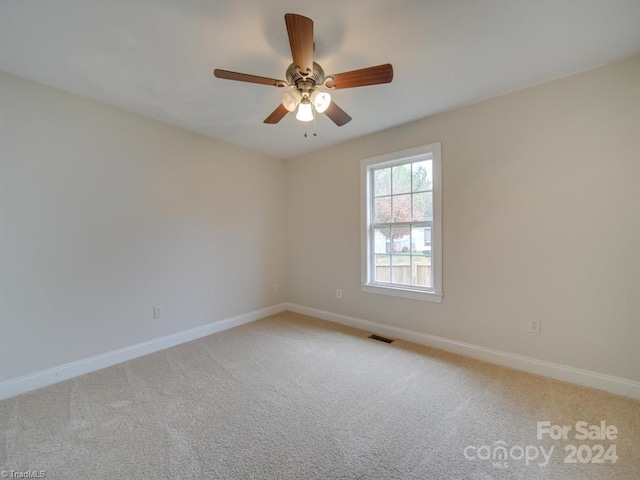 spare room with light carpet and ceiling fan