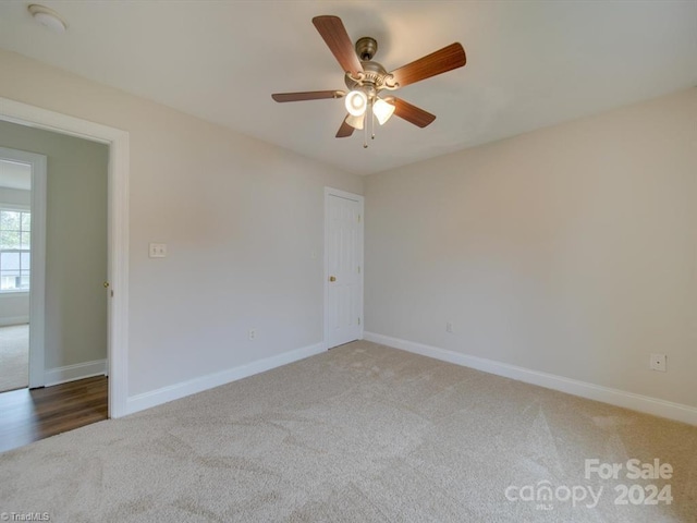 spare room featuring ceiling fan and carpet