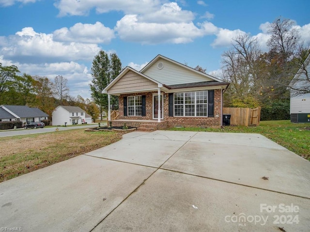 view of front of property featuring covered porch, a front lawn, and central air condition unit