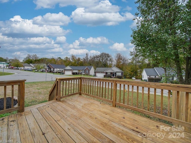 wooden deck featuring a yard