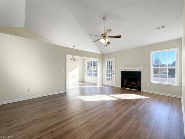 unfurnished living room with a fireplace, visible vents, vaulted ceiling, and dark wood-style flooring