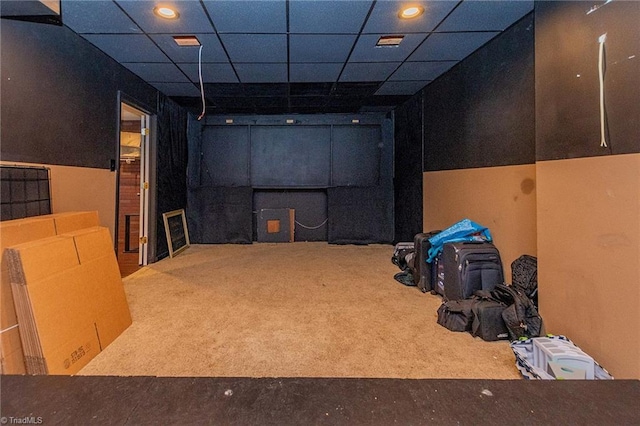 basement with carpet and a drop ceiling